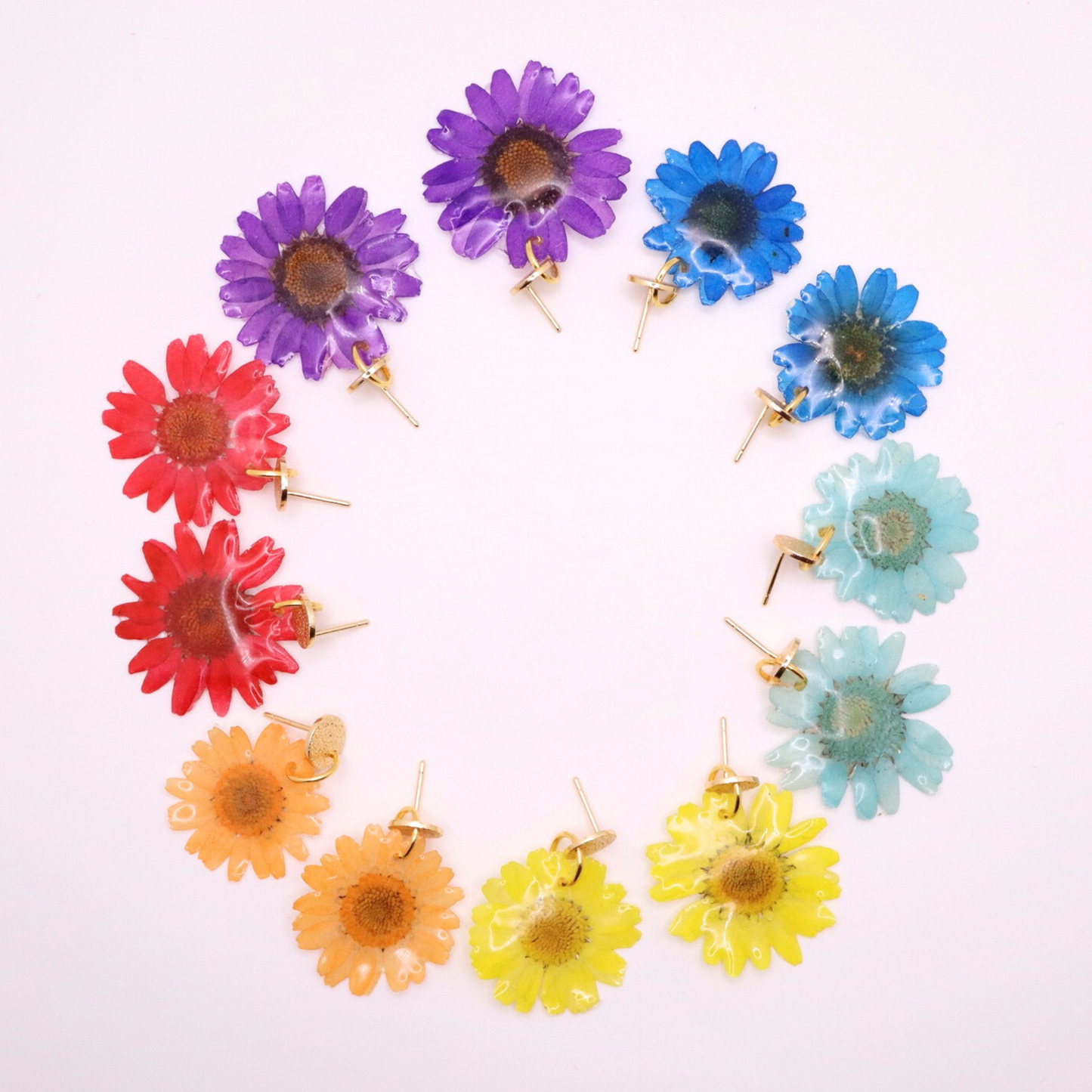 Colorful real flower resin earrings collection with 18K gold plated posts featuring blue, yellow, purple, red, and teal floral designs