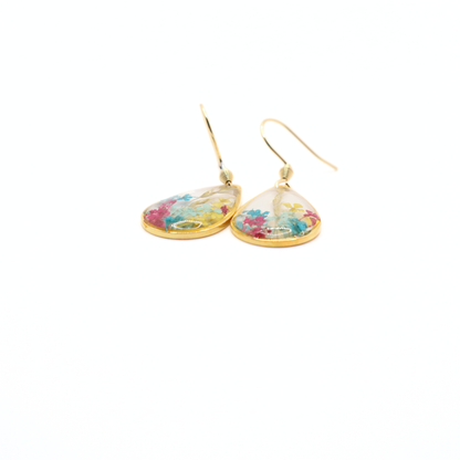 Lightweight gold teardrop dangle earrings with real dried flowers in resin, shown at an angled view on white background